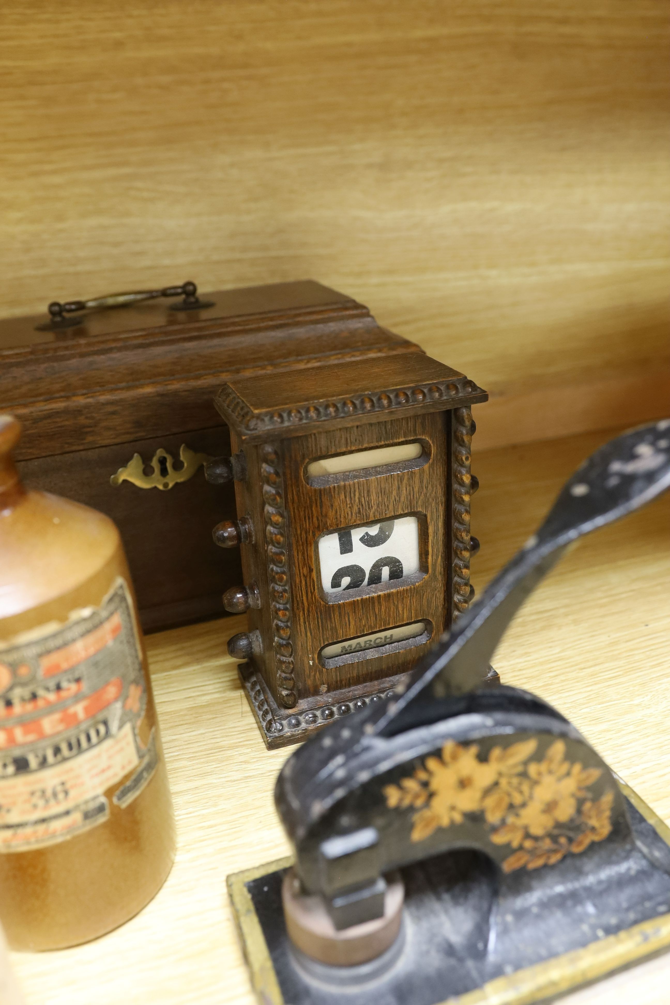 Three Victorian style desk embossing stamps, a terracotta bottle of Stephens 'Scarlet Writing Fluid', a desk calendar, oak box and a desk stand